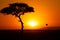 Tree silhoutte and a skyball at scenic sunset in Kenya