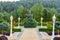 Tree in a summer park. Beautiful background of the alley in the garden with trees and lanterns. Beautifully trimmed