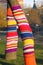 Tree trunks decorated by colorful knitwork