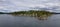 Treed Island with Homes, boats and docks, nearby smaller island with lighthouse