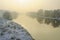 Trees covered with frost. Winter sunset, frozen river, misty scenery