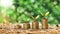 Trees growing on a pile of golden coins on a green background