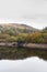 Trees, and hill reflected in water, Autumn Fall.