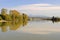 Trees on an island reflecting on river water