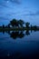 Trees and moon reflecting in the water