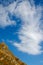 Trees and the rock, sky in sunny autumn with big cloud