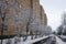 Trees after snowfall covered with frost dew at the brick living block in Mira street of Mozhaysk, Russia.