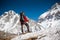 Trekker approaching PumoRi mountain in Khumbu valley on a way to