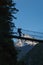 Trekker crossing suspension bridge in Khumbu valley on a way to