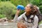 Trekker drinking water from bottle in a river