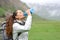 Trekker drinking water from canteen in the mountain