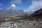 Trekker hiking on the trail to Ama Dablam base camp with Tabuche peak on backdrop, Nepal