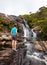 Trekker looks at wild waterfall