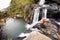 Trekker looks at wild waterfall in Horton Plains National Park,