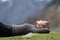 Trekker resting lying on the grass in the mountain