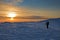 Trekker silhouette at sunset in the mountains