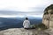 Trekker sitting in a cliff contemplating