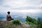 Trekker sitting on the mountain with Beautiful Sunrise and sea of mist in the morning on Khao Luang mountain in Ramkhamhaeng Natio