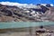 A trekker takes in views of Ausangatecocha lake. Cordillera Vilcanota, Cusco, Peru