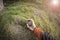 A trekker using gps among the forest in a cloudy day