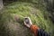 A trekker using gps among the forest in a cloudy day