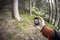 A trekker using gps among the forest in a cloudy day