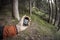 A trekker using gps among the forest in a cloudy day