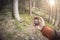 A trekker using gps among the forest in a cloudy day