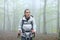 Trekker woman walking in a forest in winter