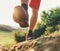 Trekking boot sole close up image traveler feet in trekking boots on mountain dirty path at summertime