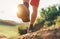 Trekking boot sole close up image traveler feet in trekking boots on mountain dirty path at summertime