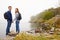 Trekking couple taking a break at the edge of a lake