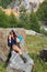 Trekking girl on a mountain rock relaxing