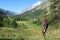 Trekking girl on mountain trail in Ferret Valley