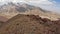 Trekking near the base camp under Lenin Peak, Kyrgyzstan. Several tourists are walking along a mountain path.