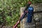 Trekking pole, water bottle and compass isolated on a rock outdoor