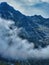 Trekking on snow mountain. Cloudy day in green mountains. Carpathian mountains shot from drone at sunset. View from helicopter.