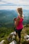 Trekking - woman hiking in mountains on a calm sumer day