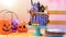 On trend Halloween candyland novelty drip cake in colourful party setting.