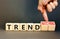 Trend or trendwatching symbol. Concept words Trend and trendwatching on wooden cubes. Businessman hand. Beautiful grey table grey