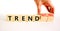 Trend or trendwatching symbol. Concept words Trend and trendwatching on wooden cubes. Businessman hand. Beautiful white table