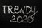 Trend word 2020 written in white chalk on a black chalkboard