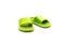 A trending cute pair of green open toe pillow slide sandals for toddler non-slip foam slippers isolated on white