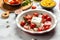 Trending viral Feta pasta recipe with tomatoes, cheese, garlic and herbs in a casserole dish. cooking recipe ingredients, place