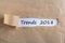 Trends 2018 concept. Message appearing behind ripped brown paper. Targets, goal, dreams and New Year`s expectation for