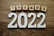 Trends 2022 word alphabet letters on wooden background