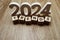 Trends 2024 word alphabet letters on wooden background