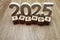 Trends 2025 word alphabet letters on wooden background