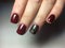 trendy burgundy manicure with black design