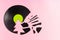 Trendy Christmas concept made of broken green label vinyl record on pink background with copy space. Creative retro music